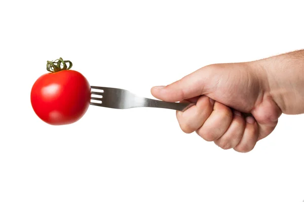 A perfect red tomato with a fork in i — Stock Photo, Image