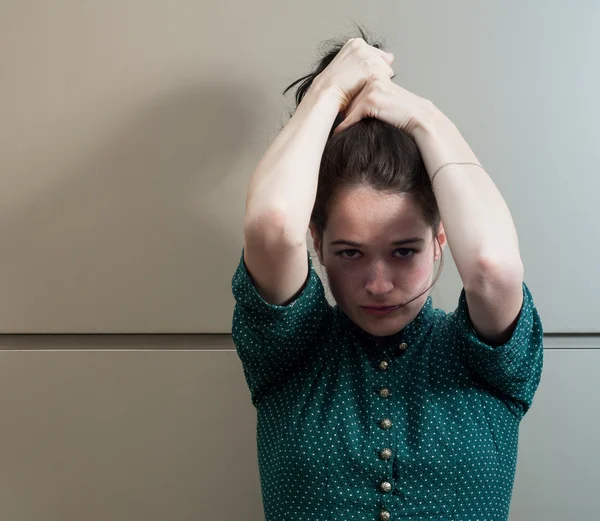 Beautiful and natural girl grasping her hair — Stock Photo, Image