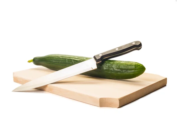 Big green cucumber and a cook knife on a wooden boar — Stock Photo, Image