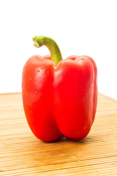 Red pepper with water drops on bamboo boar — Stock Photo, Image