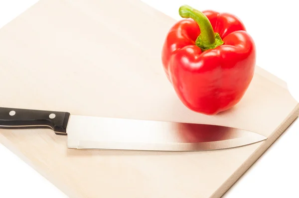 Red pepper ready to be cut on a wooden boar — Stock Photo, Image