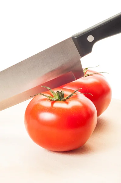 Two red tomatoes and a steel knif — Stock Photo, Image