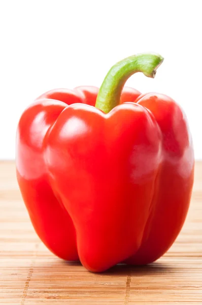 Closeup of one red pepper on wooden plat — Stock Photo, Image