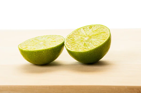 Half lime on wooden boar — Stock Photo, Image