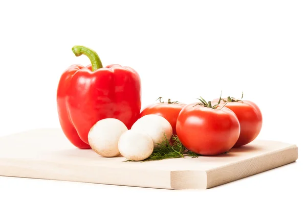 Mushrooms, tomatoes, red pepper and some dill on wooden plat — Stock Photo, Image