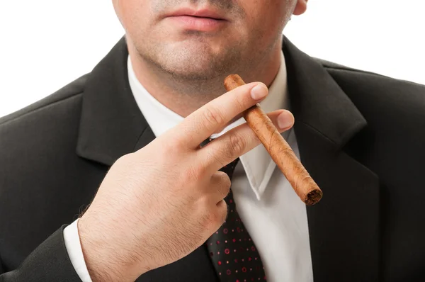 Pewnie biznesmen gospodarstwa papierosa kubański — Zdjęcie stockowe