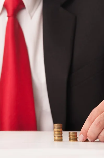 Business man counting piles of coin — Stock Photo, Image