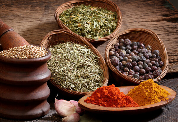 Different spices over a wood background.