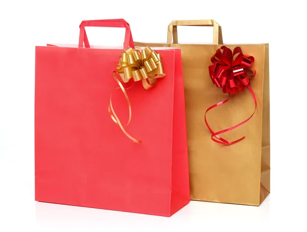 Two paper shopping bags with a ribbon over white — Stock Photo, Image