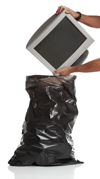 Man throwing a pc monitor in the garbage bag — Stock Photo, Image