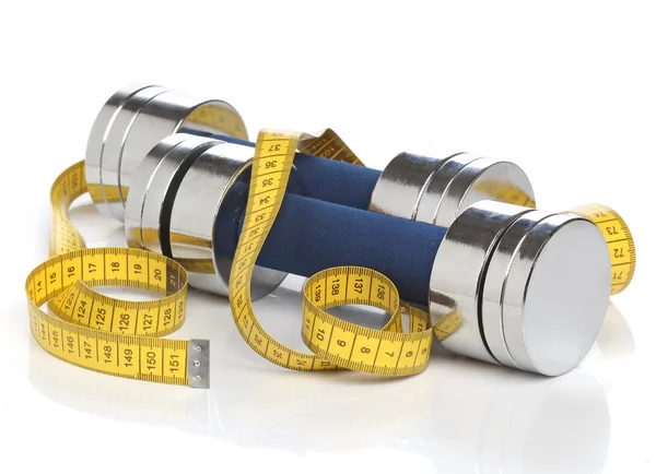 Dumbbells and a measuring tape over white — Stock Photo, Image