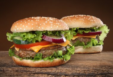ahşap zemin üzerinde iki lezzetli hamburger.