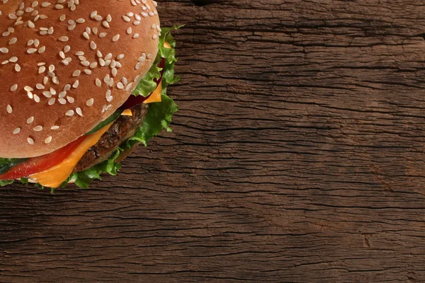 Tasty hamburger on wood background. Space for text — Stock Photo, Image