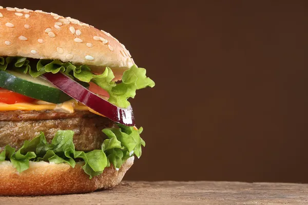 Tasty hamburger on wood background — Stock Photo, Image