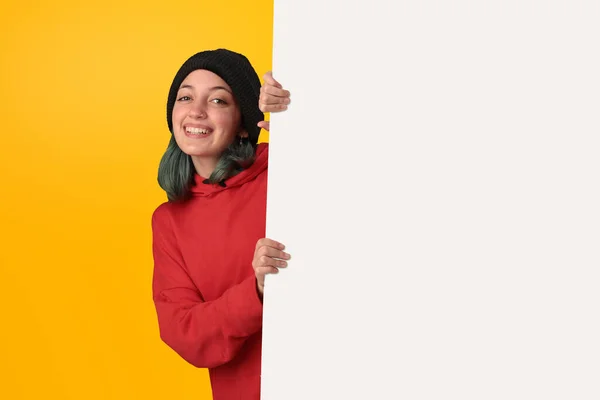 Lovely Young Girl Holding Big Blank Board Yellow Background lizenzfreie Stockbilder