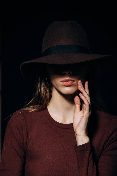 Girl in a hat with brim. Portrait of a girl in a brown hat