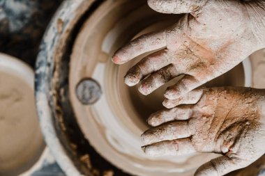 Kadın seramikçi elleri kil tabakları yontuyor