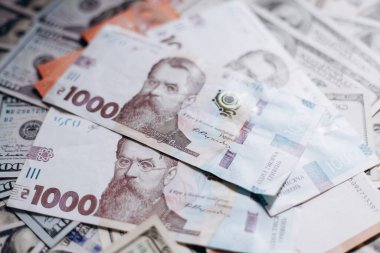 Dollar banknotes of the USA. Amerikan dollars. Money of USA and Ukrainian hryvnia. 1000 Ukrainian hryvnia