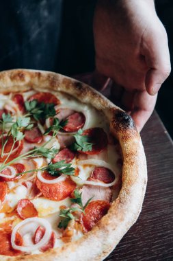 Orange fresh with sea buckthorn in a faceted glass and pizza from a slice and pizza