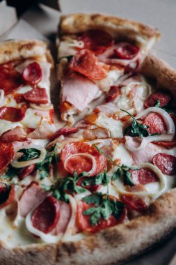 Orange fresh with sea buckthorn in a faceted glass and pizza from a slice and pizza