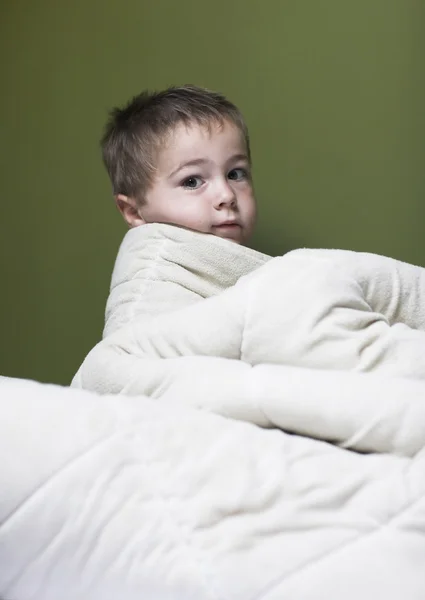 Little boy hides under white blanket — Stock Photo, Image