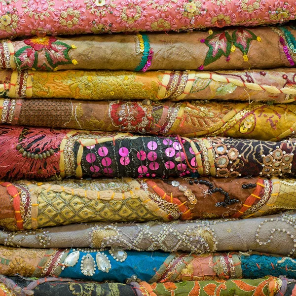 Heap of cloth fabrics at a local market in India. Close up . — Stock Photo, Image