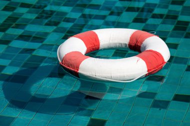 Yaşam halkası güneşli mavi suyun üzerinde yüzüyor.