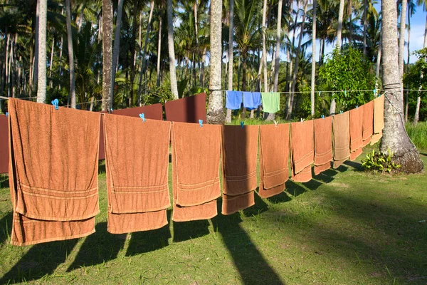 Fresh clean hotel towels drying on a line outdoors — Stock Photo, Image
