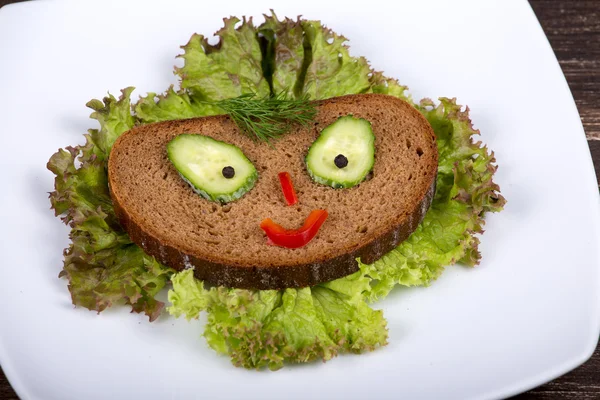 Fun food for kids - face on bread — Stock Photo, Image