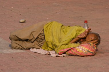 Homeless man in Haridwar, India. clipart