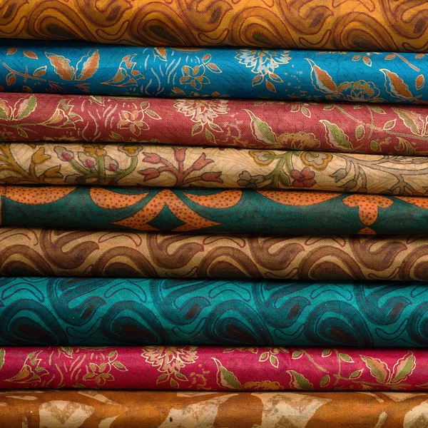 Heap of cloth fabrics at a local market in India. Close up . — Stock Photo, Image