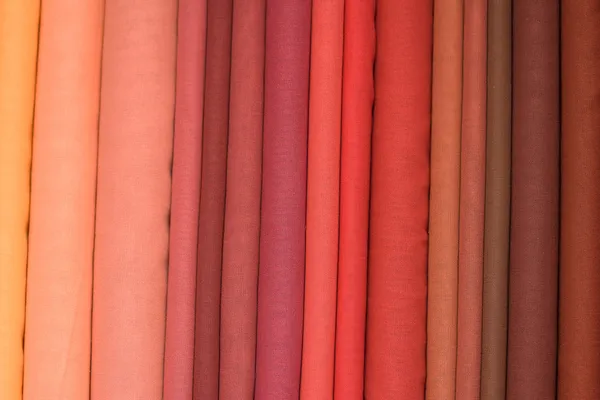 Heap of cloth fabrics at a local market in India. Close up . Stock Photo