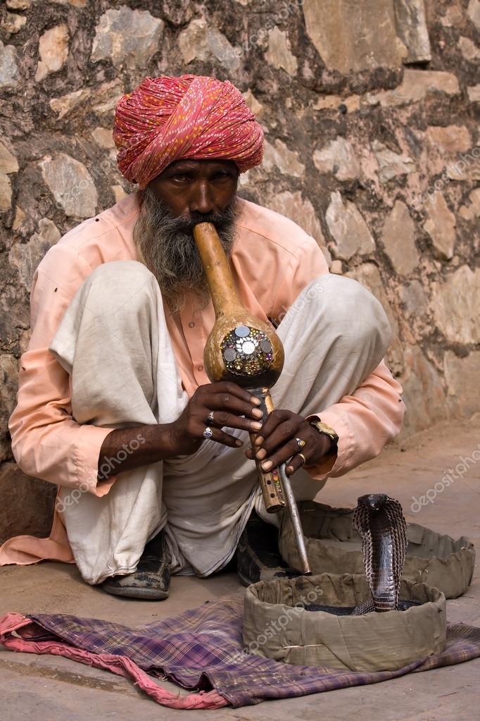 Snake charmer is playing the flute for the cobra in Jaipur, India