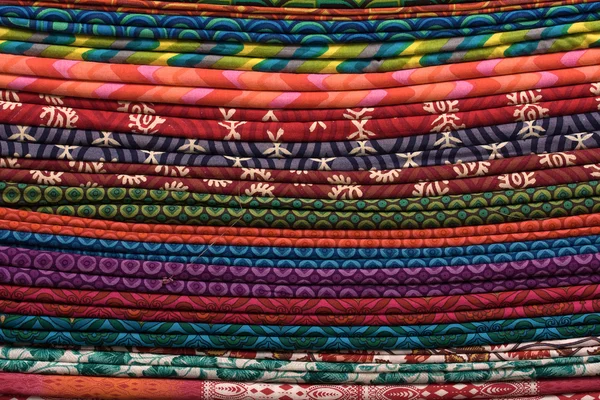 Un mucchio di stoffe in un mercato locale in India. Da vicino.  . — Foto Stock