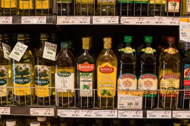 Selection of olive oil on the shelves in a supermarket Siam Paragon in Bangkok. clipart