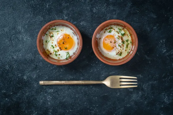 目の形で丸いセラミック皿の中に2つの目玉焼き 調理された小さな目玉焼きはシンプルな朝食です トップビュー 閉じます — ストック写真