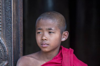 Mandalay, Myanmar, Burma - Jan 17, 2016 : Young monk at Shwenandaw Monastery is built in the traditional Burmese architectural style, Mandalay, Myanmar