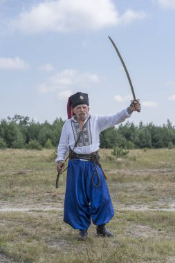 Slavuta, Ukrayna - 01 Ağustos 2021: Ukraynalı ulusal kostümlü yaşlı adam Ukrayna 'nın Slavuta kentinde düzenlenen etnik-çevre festivaline katıldı. Ulusal Ukrayna elbiseli Kozak