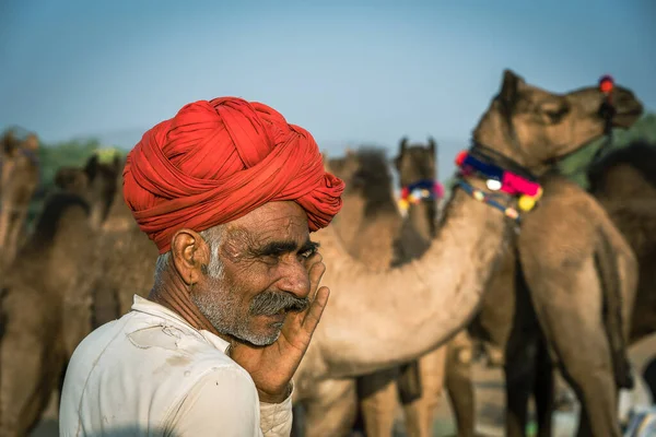 Pushkar, Hindistan - 14 Kasım 2018: Hindistan 'ın kutsal şehri Pushkar, Rajasthan yakınlarındaki Pushkar Camel Mela sırasında çölde yaşayan Hintli adam. Bu fuar dünyanın en büyük deve ticaret fuarı.
