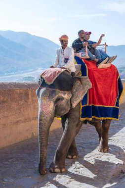 Jaipur, Hindistan - 26 Kasım 2018: Madalyalı filler eski Hindistan 'ın Rajasthan kentindeki Jaipur Kalesi' nde turistlere biniyor