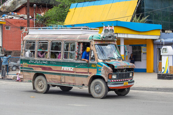 Srinagar, India - july 02, 2015 : Old Indian bus together with passengers on the road of Srinagar city, Jammu and Kashmir, India