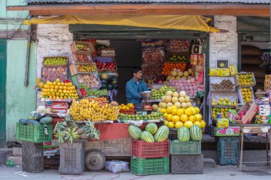 Srinagar, Hindistan - Temmuz 03, 2015: Hintli adam Hindistan 'ın Srinagar, Jammu ve Kashmir eyaletlerindeki bir sokak pazarında meyve satıyor