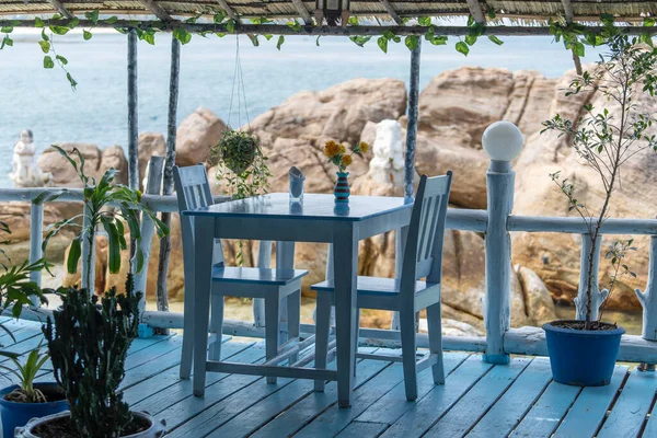青い海の水の近くのトロピカルビーチカフェで木製のテーブルと椅子 タイの島 パンガン島 海の近くのビーチカフェ 旅行と休暇のコンセプト — ストック写真