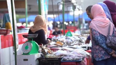 Kota Kinabalu, Malaysia - february 25, 2020 : Malaysian people sells and buy seafood at the night street food market in Kota Kinabalu, Borneo Island, Malaysia