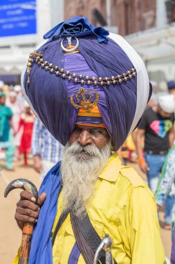 Amritsar, India - Sep 27, 2014 : Sikh man visiting the Golden Temple in Amritsar, Punjab, India. Sikh pilgrims travel from all over India to pray at this holy site