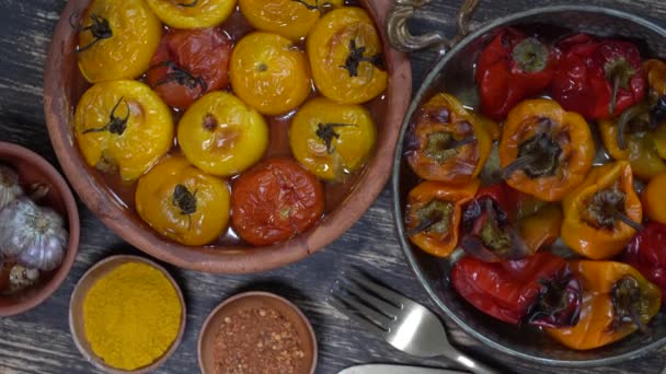 赤と黄色のトマトとピーマンを焼き 木製のテーブルの上にベーキング皿にトマトとピーマン ヘルシーでおいしいベジタリアン料理 上の図を閉じて回転します — ストック動画