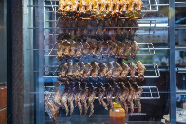 Fried chicken wings at street food market in Kota Kinabalu, island Borneo, Malaysia, close up