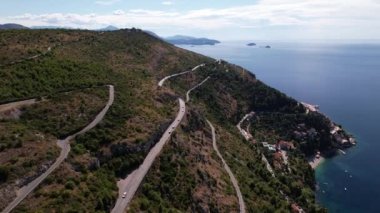 Flying over the mountain road and sea at summer sunny day in Croatia, Central Europe, travel and nature concept. Beautiful landscape and blue sea with mountain near Dubrovnik city