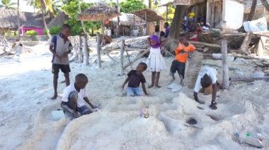 Zanzibar, Tanzania - december 11, 2019 : African children playing on sand tropical beach near sea on island of Zanzibar, Tanzania, East Africa, close up