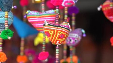 Colorful handmade souvenirs for sale in local street market in mountain village Sapa, Vietnam, close up